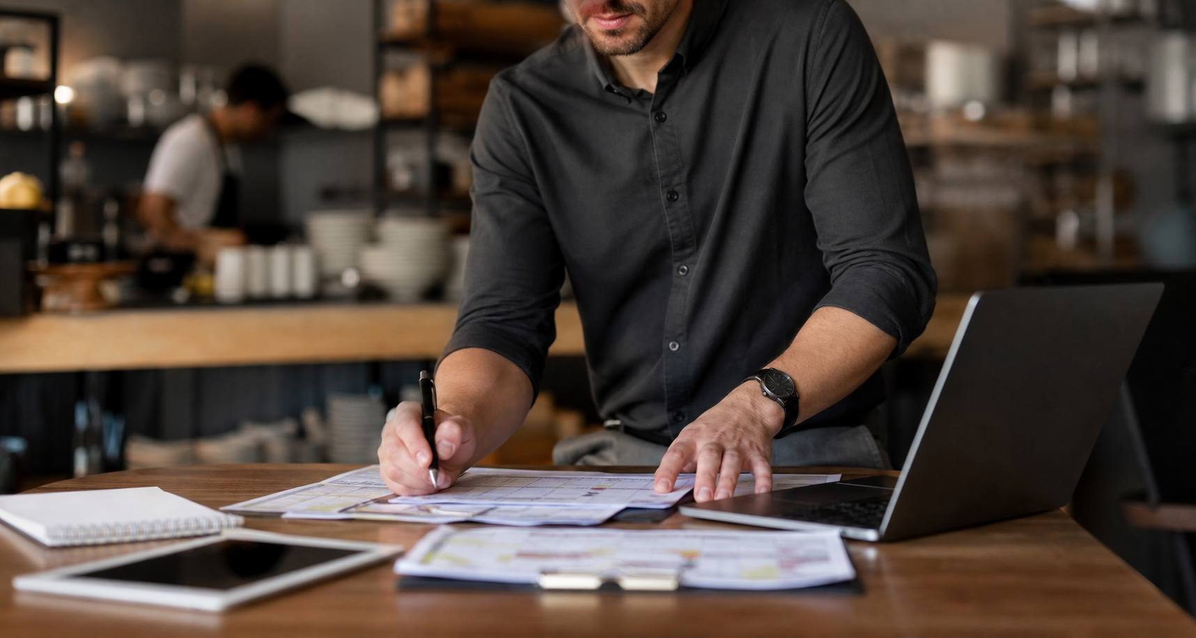 Operations planning workspace with laptop, checklist, and business documents